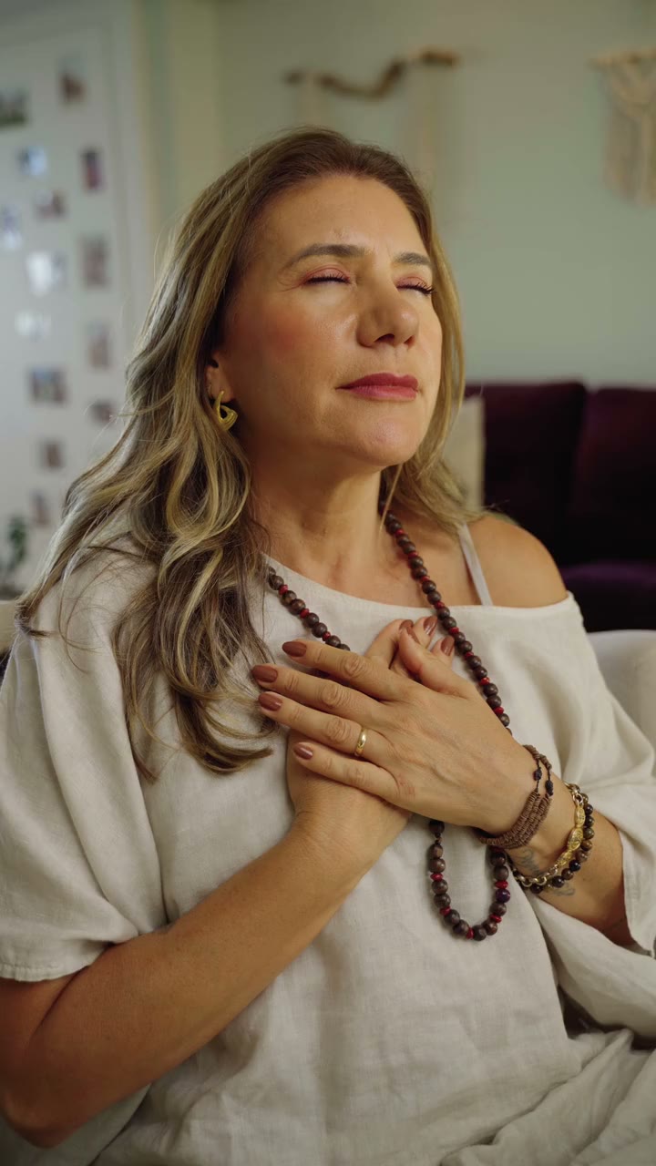Vanessa de olhos fechados, com as mãos no peito